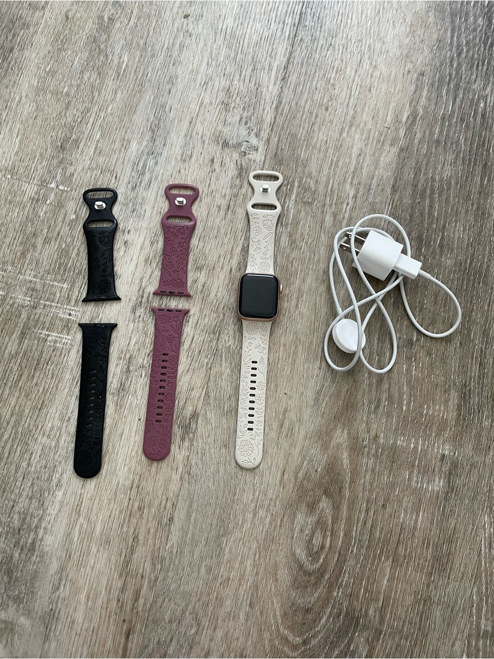 Apple Smartwatch with White, Black, and Mauve Bands